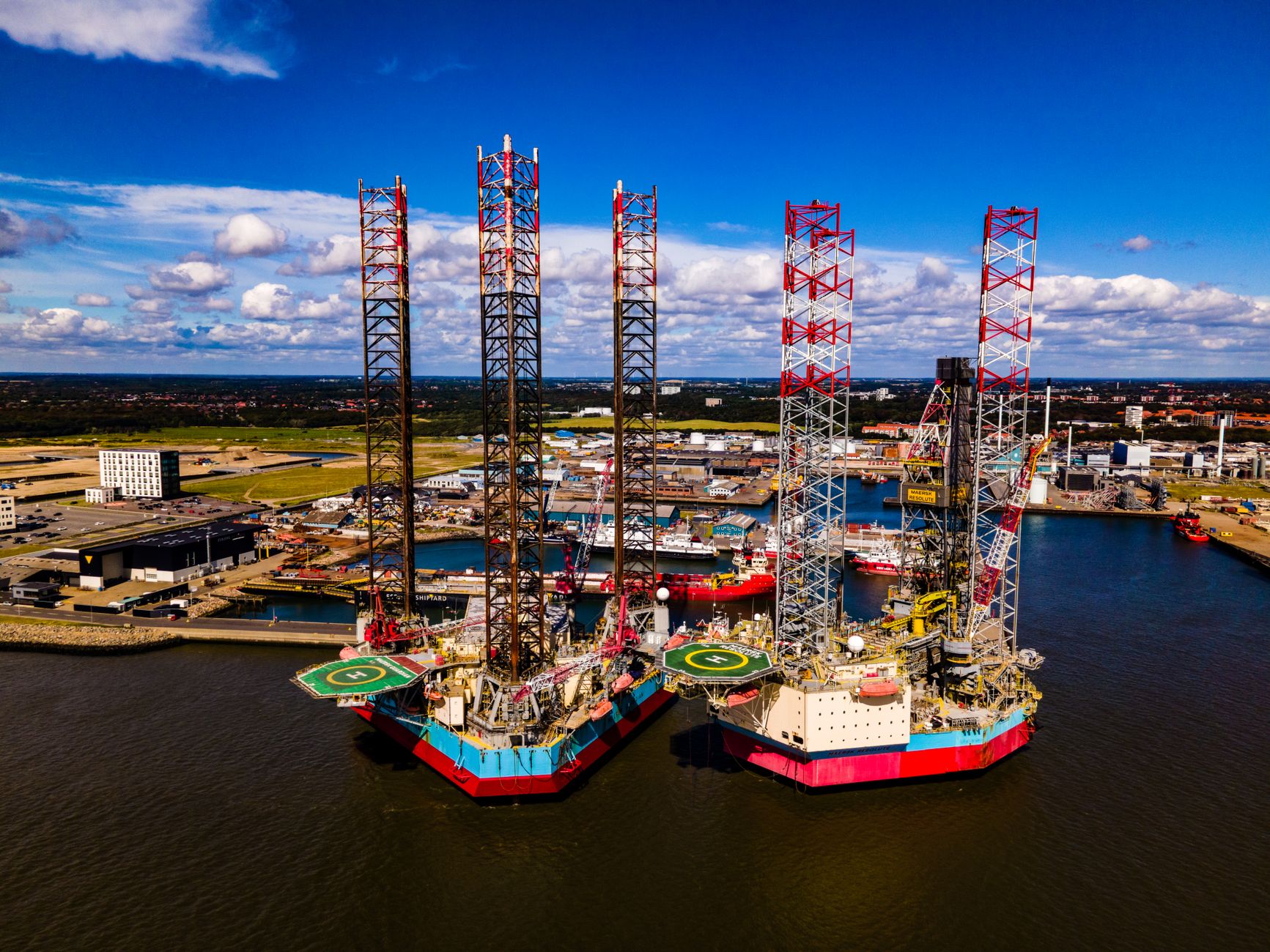 jackdaw gas field approval: Stunning aerial view of oil rigs docked at the port of Esbjerg in Denmark. Clear day with vibrant